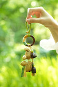 "The Forest Rattle" - Colorful Wrapped Wood Ring & Nut Shell Bag Charm with Tassels