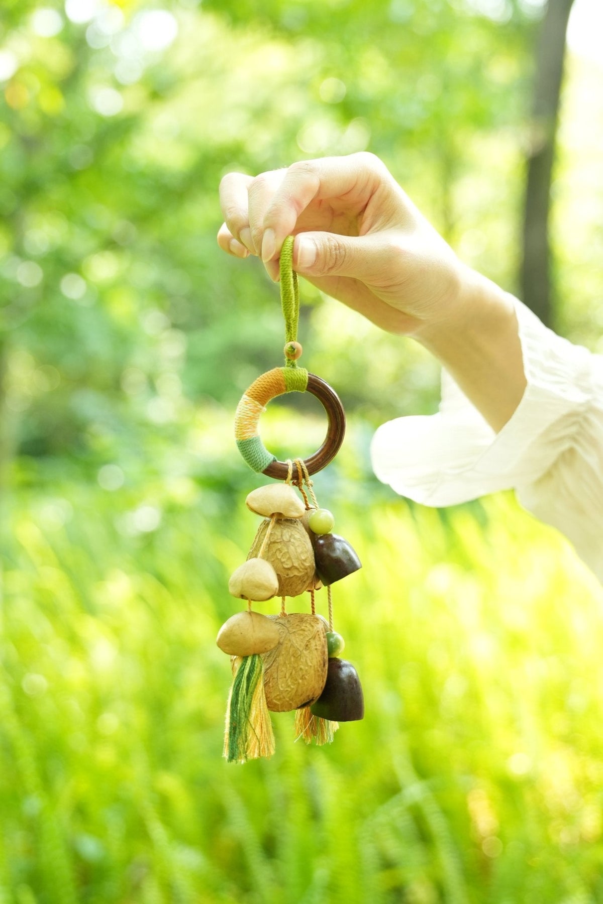 "The Forest Rattle" - Colorful Wrapped Wood Ring & Nut Shell Bag Charm with Tassels