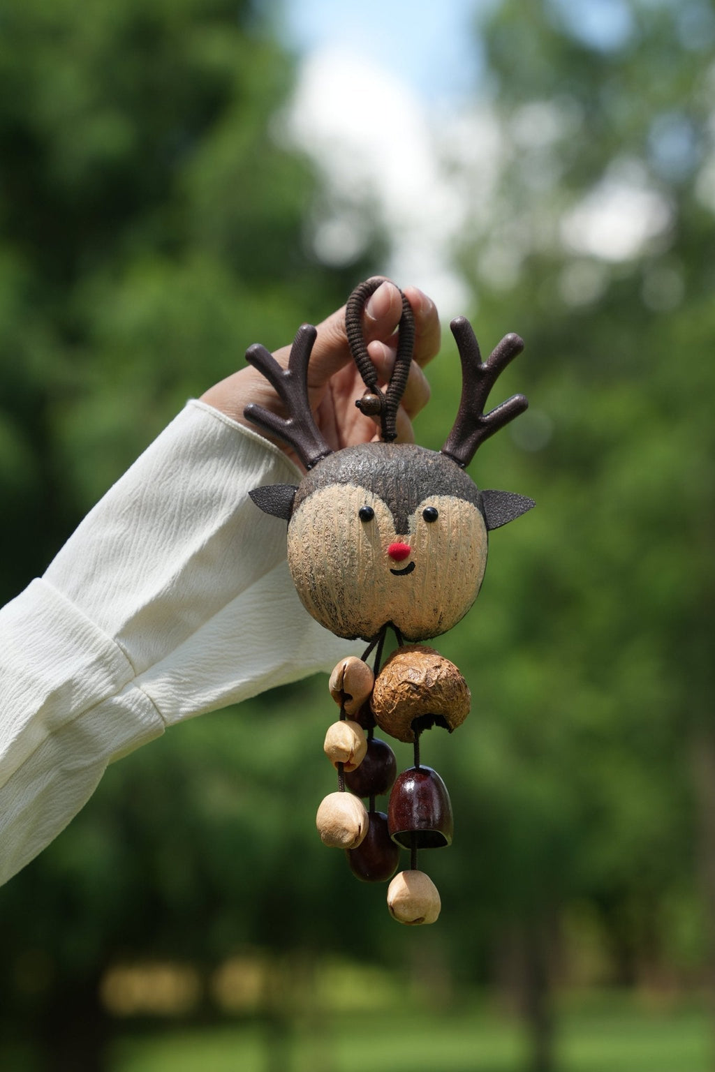 "The Forest Reindeer" - Hand-Painted Shell Charm with Antlers & Seed Bells