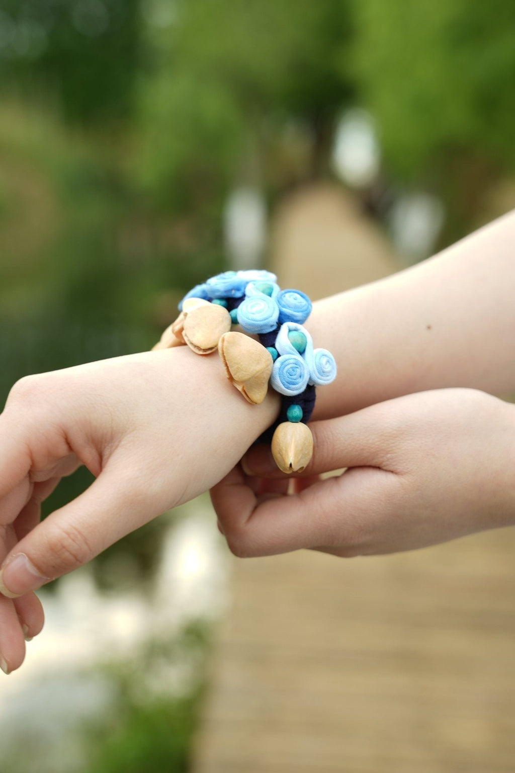 "The Indigo Ripple" - Handcrafted Blue Fabric Rosette Wrist Rattle with Seed Bells