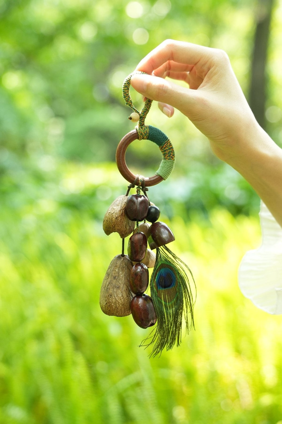 "The Peacock Spirit" - Yarn-Wrapped Wood Ring Charm with Real Peacock Feather & Seeds